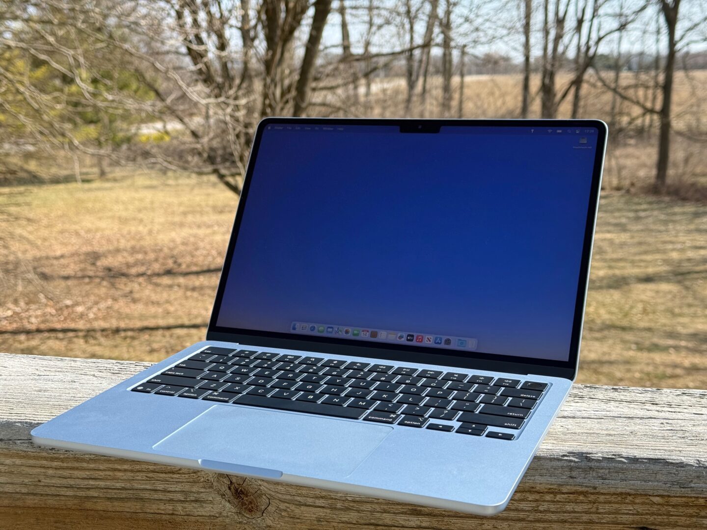 MacBook Air M4 – Outside M4 MacBook Air sitting on a porch railing outside in broad daylight
