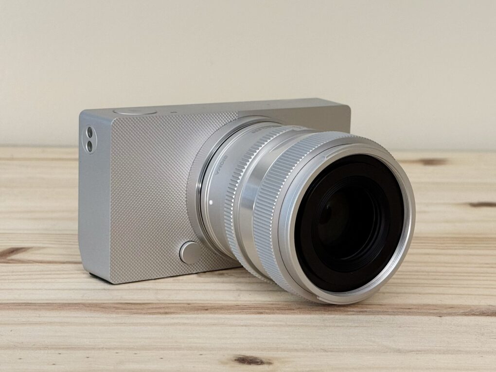 The Sigma BF, a simple aluminum full frame camera, sitting on a pine table