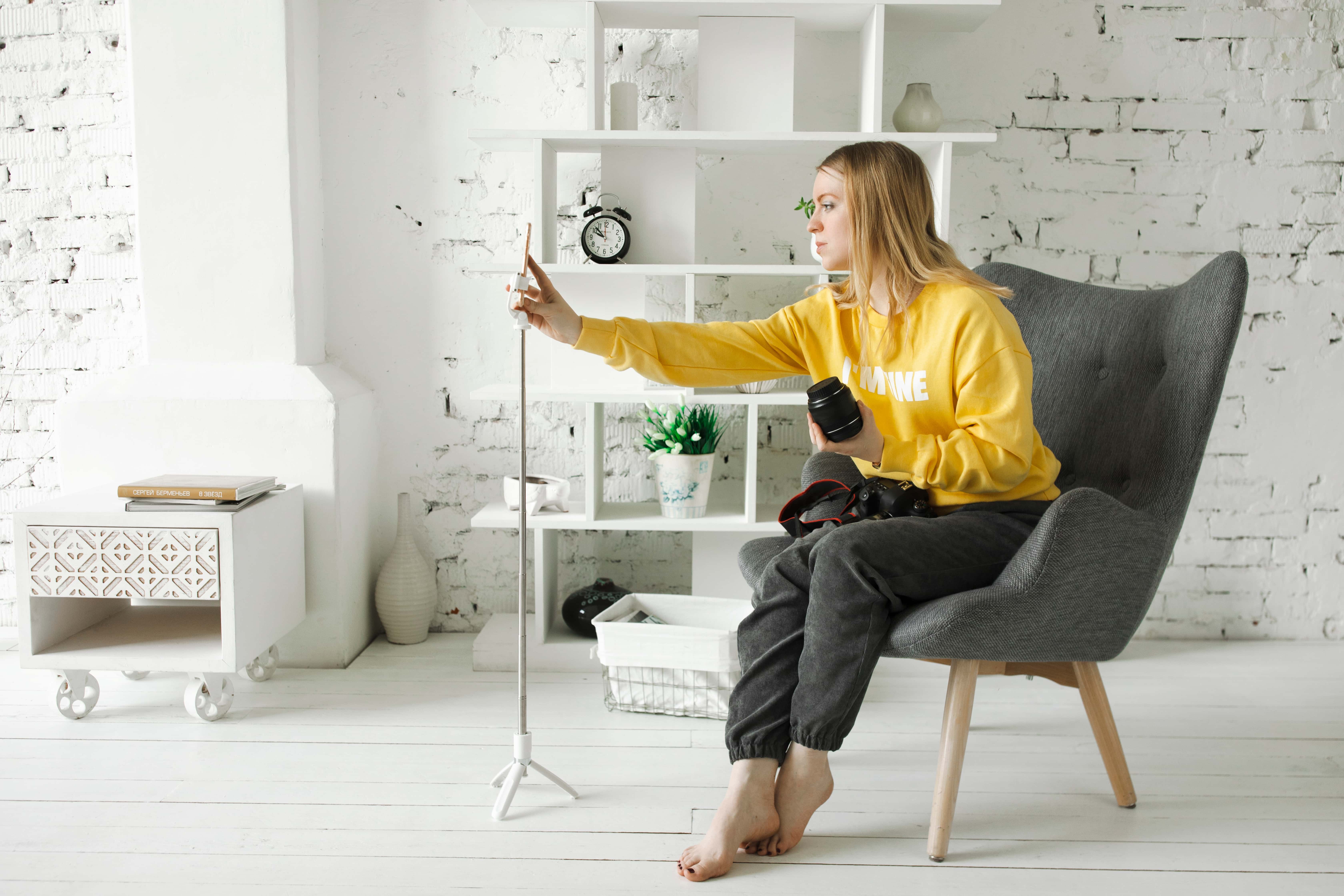 A young woman influencer works to produce video content.